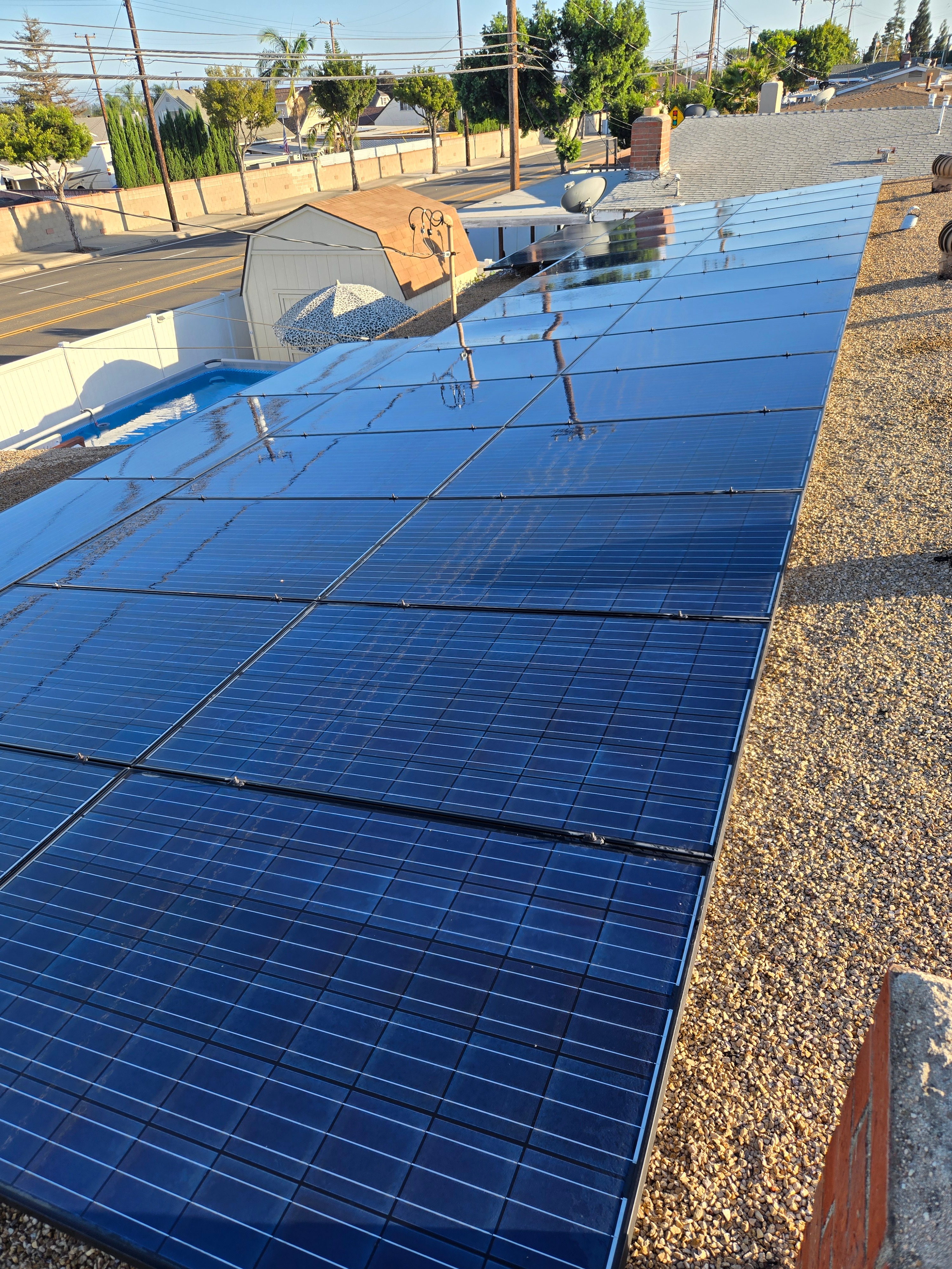 Rooftop solar panels cleaned to a glossy, reflective blue finish